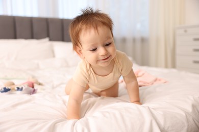 Photo of Cute little baby on bed at home
