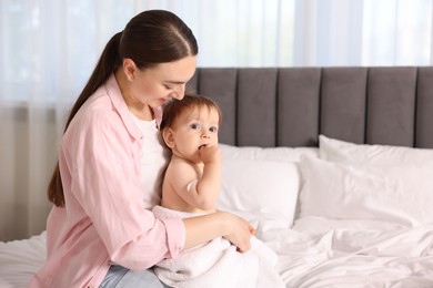 Photo of Mother and baby with cream on his arm at home. Space for text