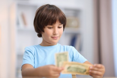Photo of Happy boy with his pocket money at home