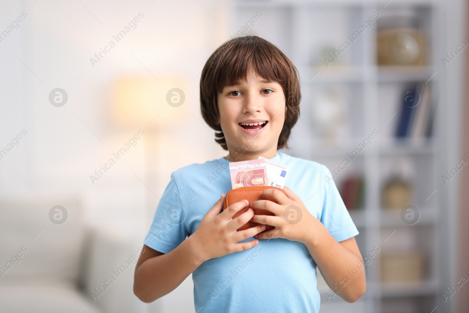 Photo of Boy with his pocket money in wallet at home