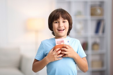 Photo of Boy with his pocket money in wallet at home