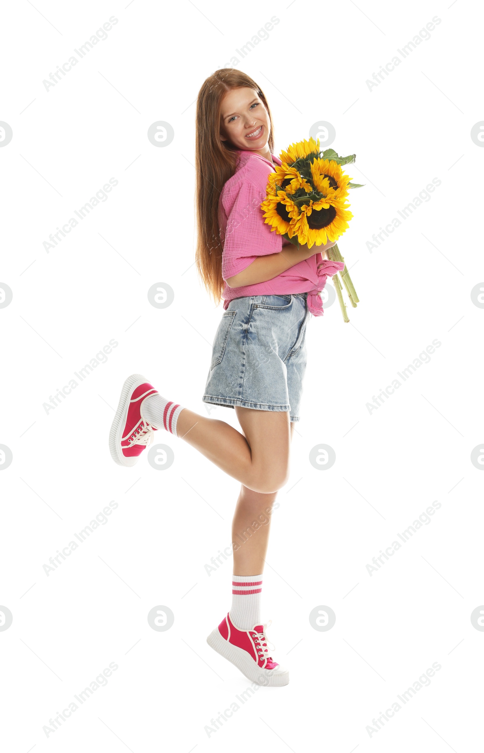 Photo of Teenage girl with bouquet of beautiful sunflowers on white background