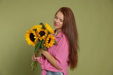 Photo of Teenage girl with bouquet of beautiful sunflowers on green background