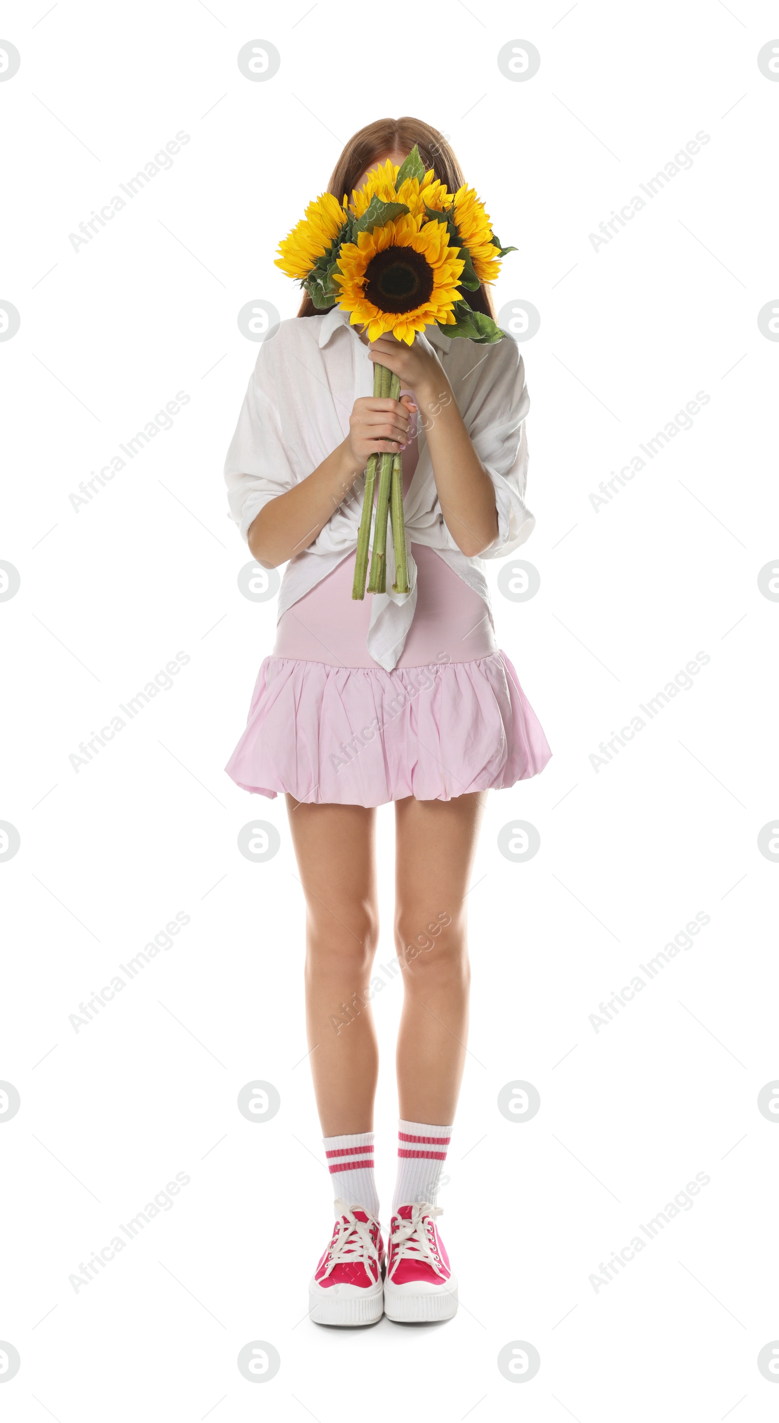 Photo of Teenage girl with bouquet of beautiful sunflowers on white background