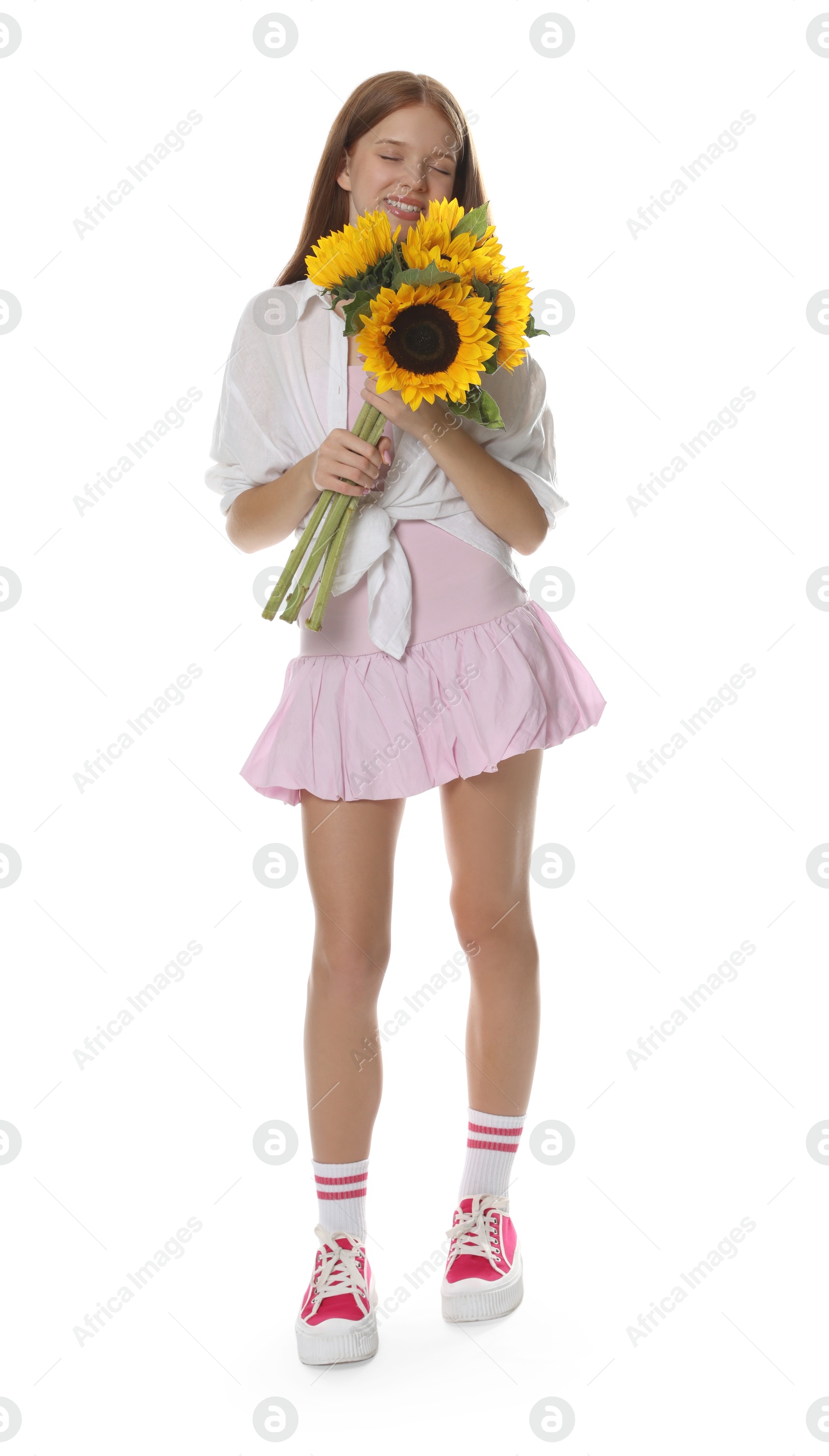 Photo of Teenage girl with bouquet of beautiful sunflowers on white background