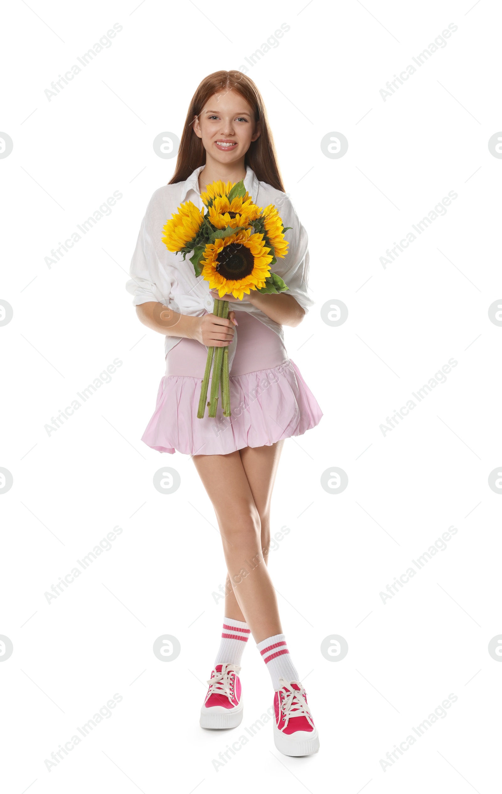Photo of Teenage girl with bouquet of beautiful sunflowers on white background