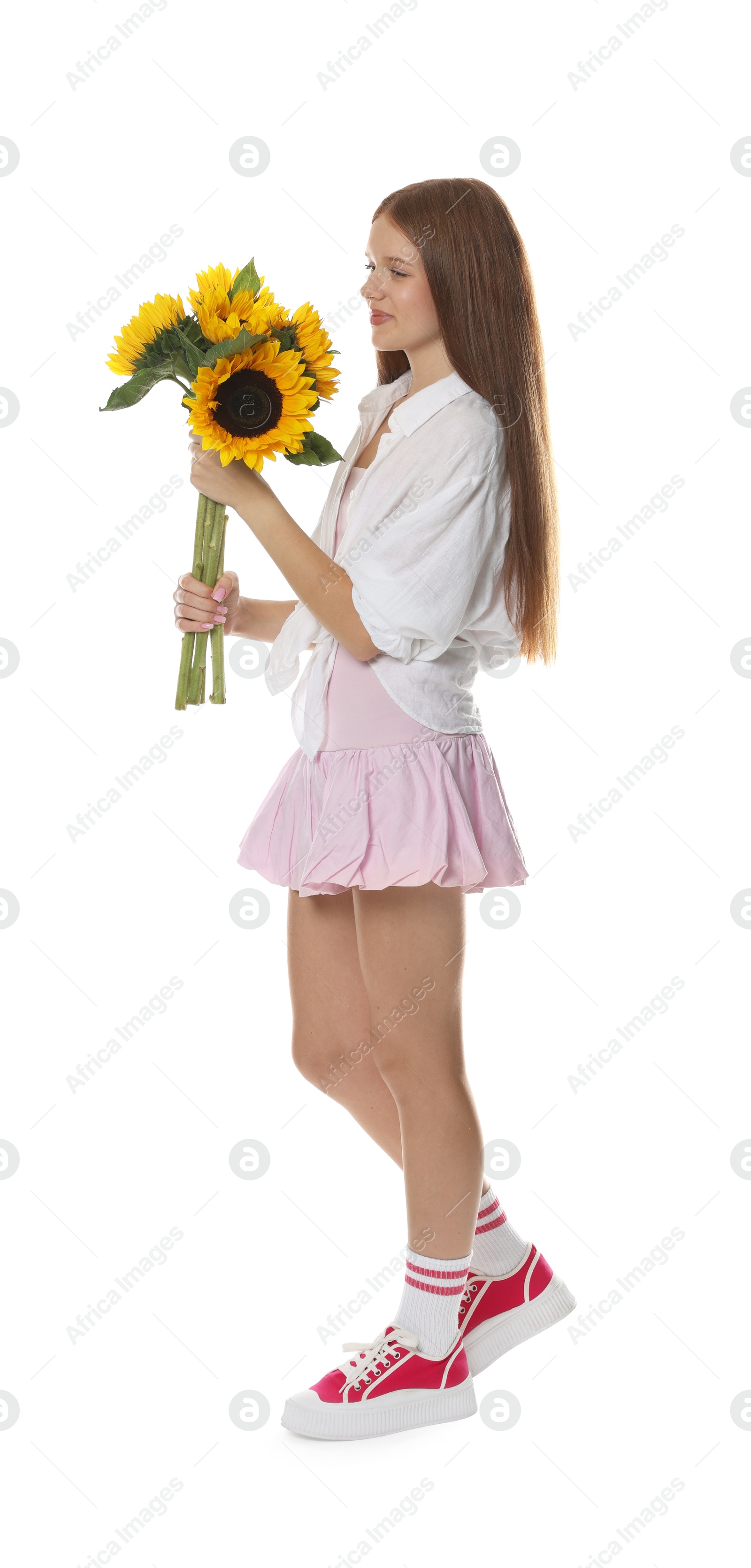 Photo of Teenage girl with bouquet of beautiful sunflowers on white background