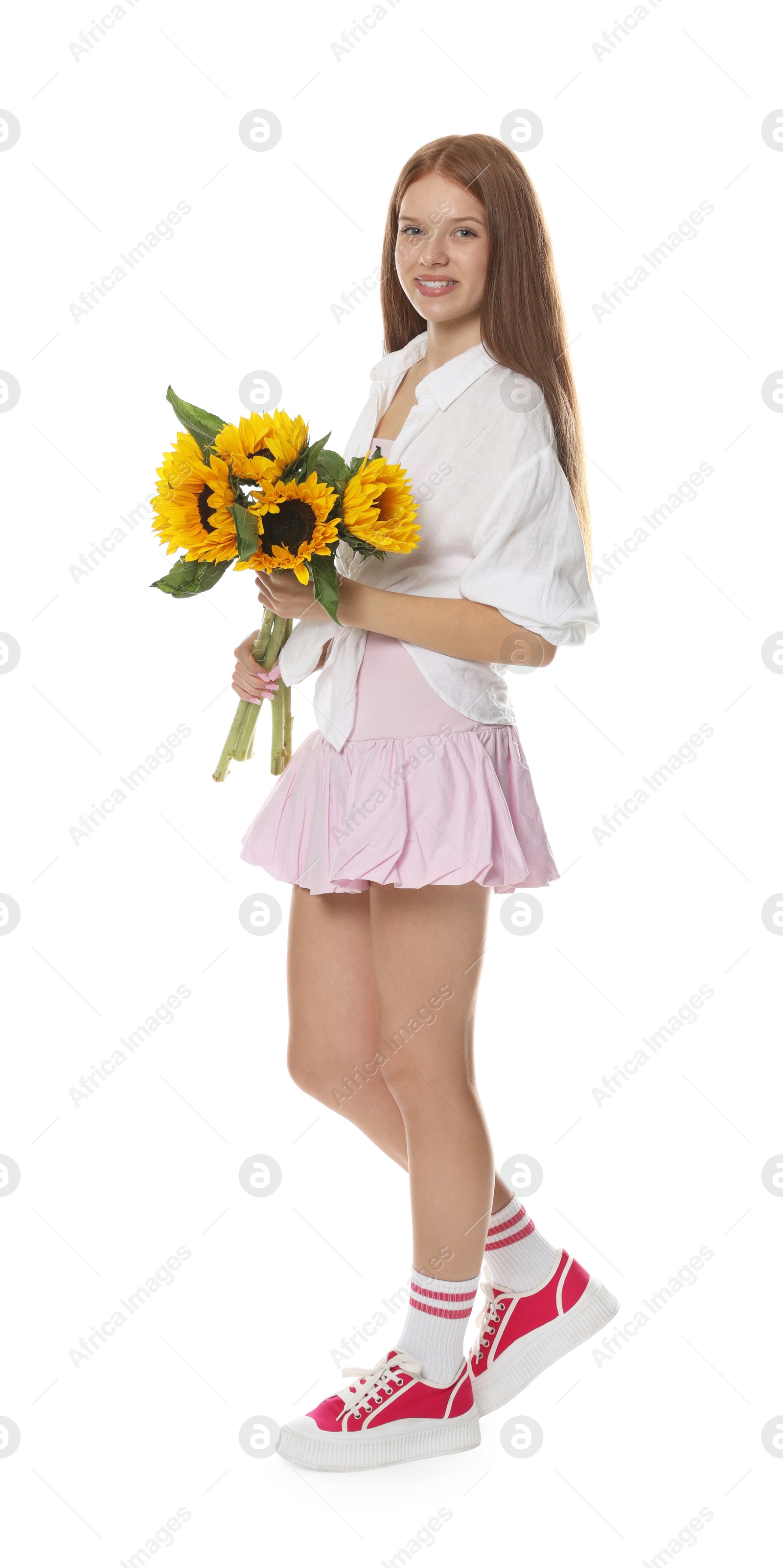 Photo of Teenage girl with bouquet of beautiful sunflowers on white background