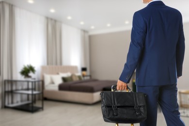 Image of Businessman with bag in hotel room, closeup