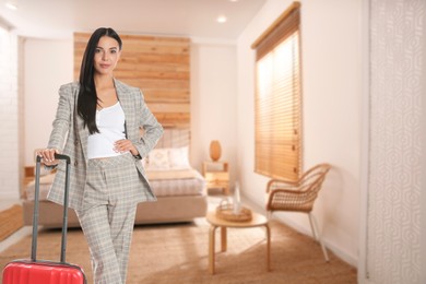 Image of Business woman with suitcase in hotel room