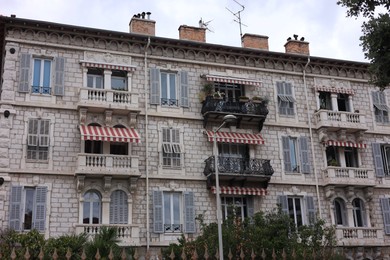 Photo of Beautiful building with windows and trees in city