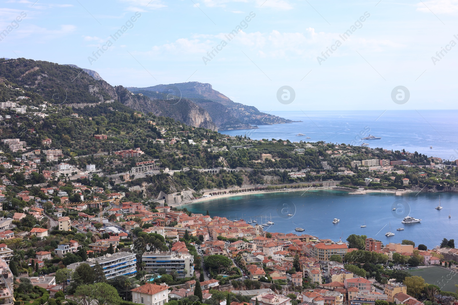 Photo of Picturesque view of city, sea and boats under beautiful sky with clouds