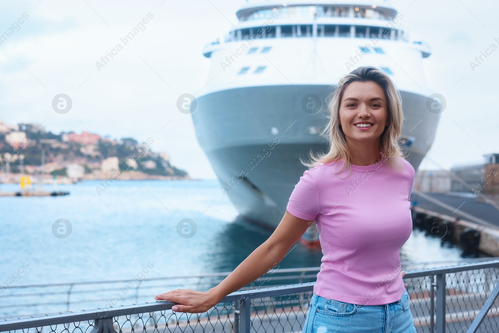 Photo of Portrait of happy young woman near canal and cruise ship outdoors, space for text