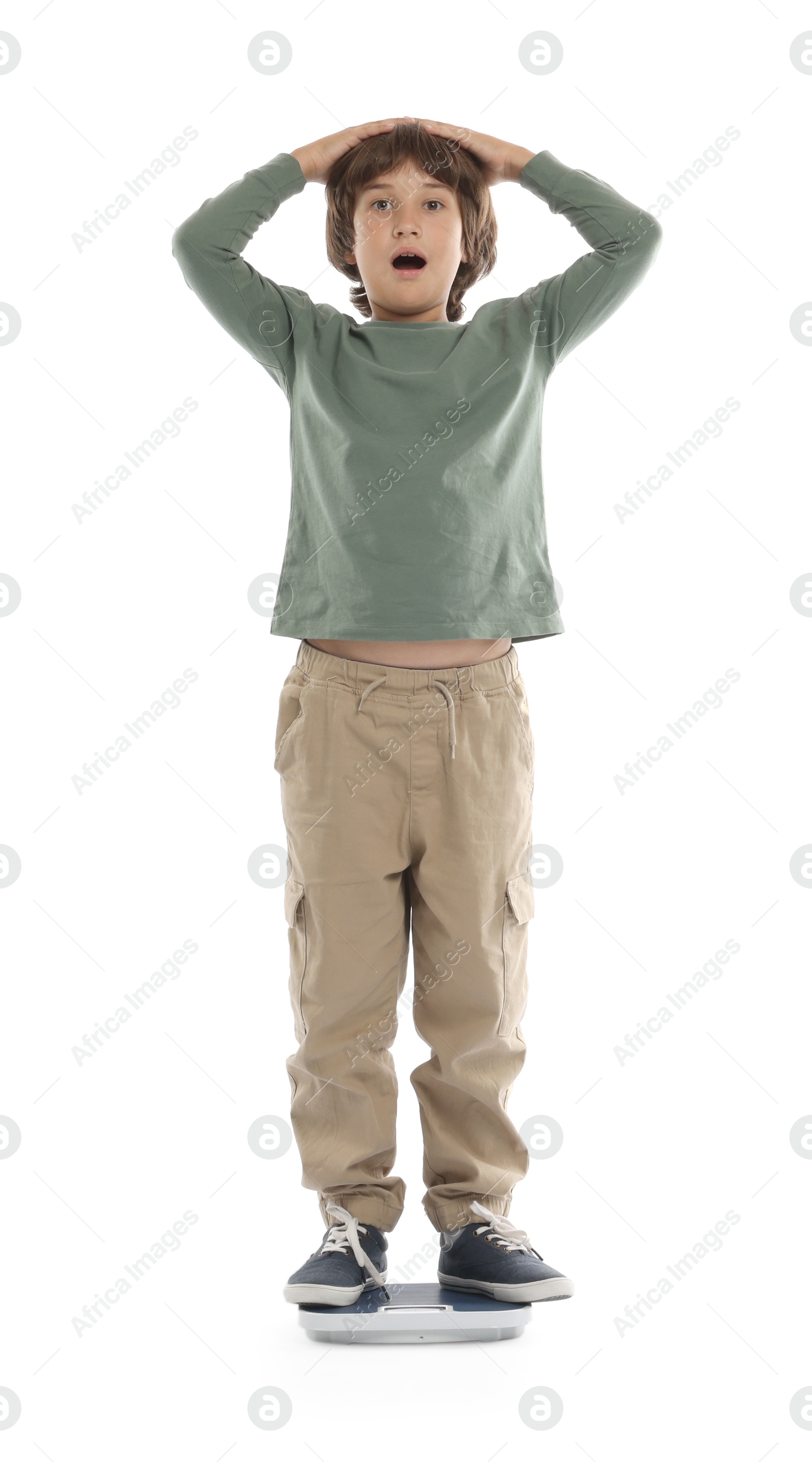 Photo of Emotional boy standing on scales at home