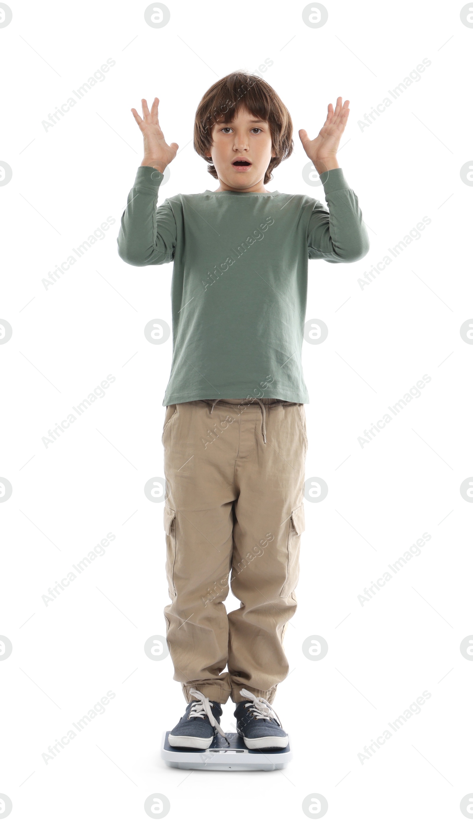 Photo of Emotional boy standing on scales at home