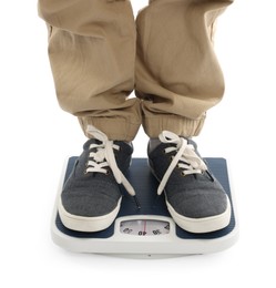 Photo of Boy standing on scales against white background, closeup