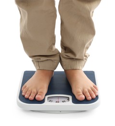 Photo of Boy standing on scales against white background, closeup