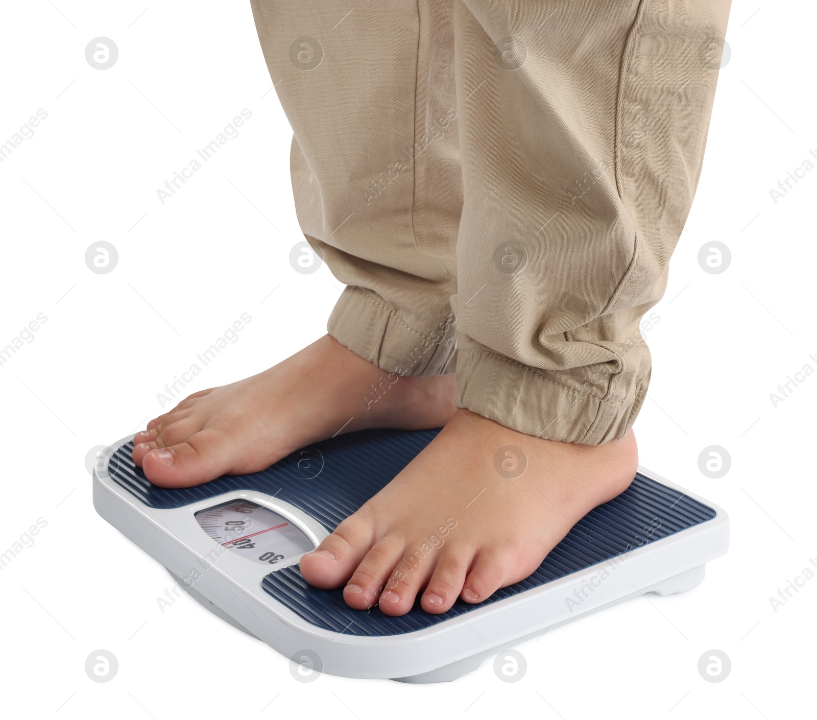 Photo of Boy standing on scales against white background, closeup