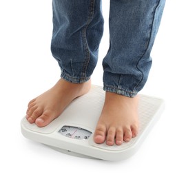 Photo of Boy standing on scales against white background, closeup