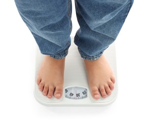 Photo of Boy standing on scales against white background, top view