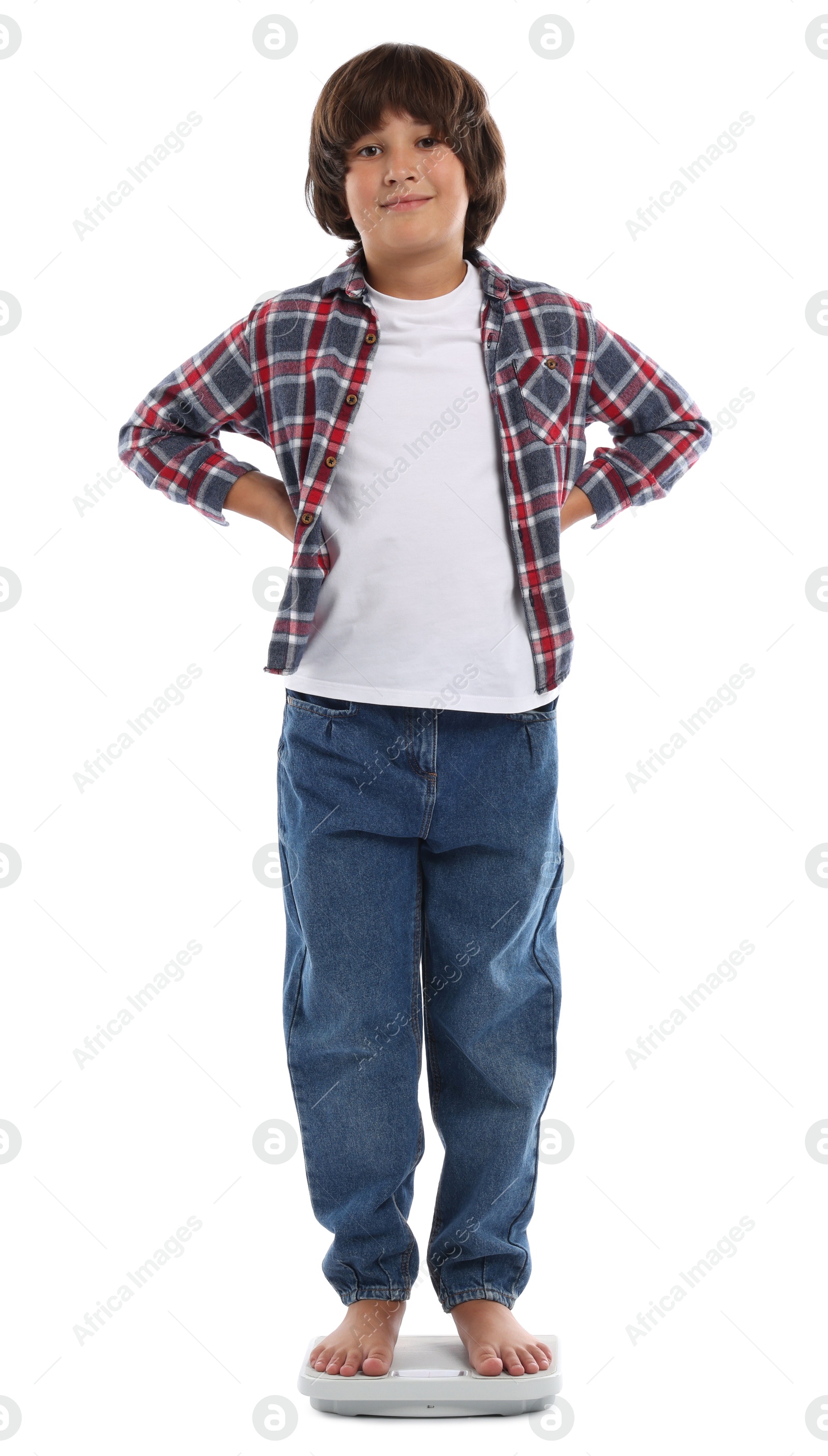 Photo of Little boy standing on scales against white background