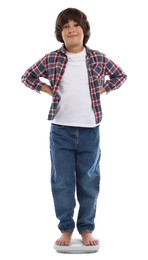Photo of Little boy standing on scales against white background