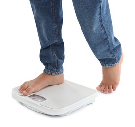 Photo of Boy standing on scales against white background, closeup