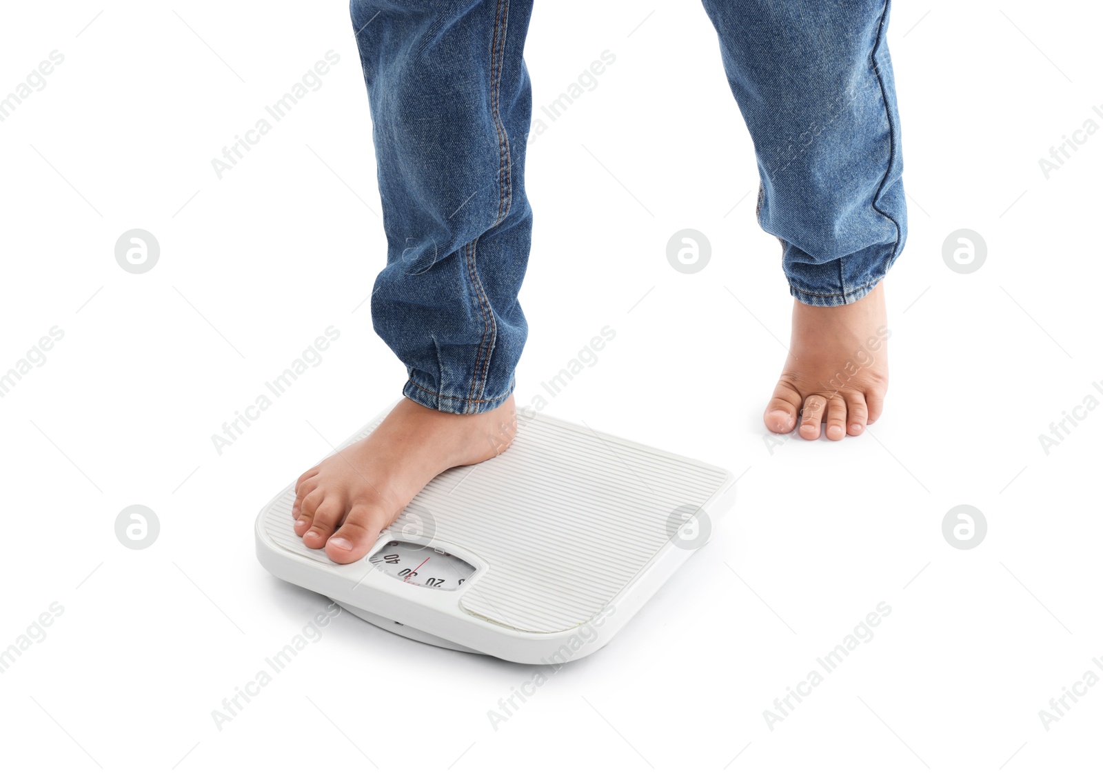 Photo of Boy standing on scales against white background, closeup