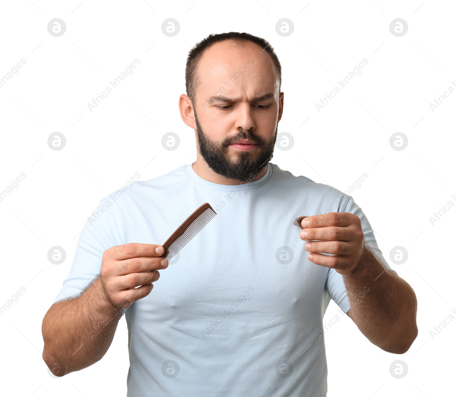 Photo of Baldness problem. Worried man with comb and clump of lost hair on white background