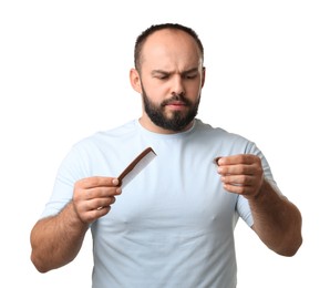 Photo of Baldness problem. Worried man with comb and clump of lost hair on white background