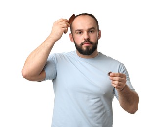 Photo of Baldness problem. Man with comb and clump of lost hair on white background