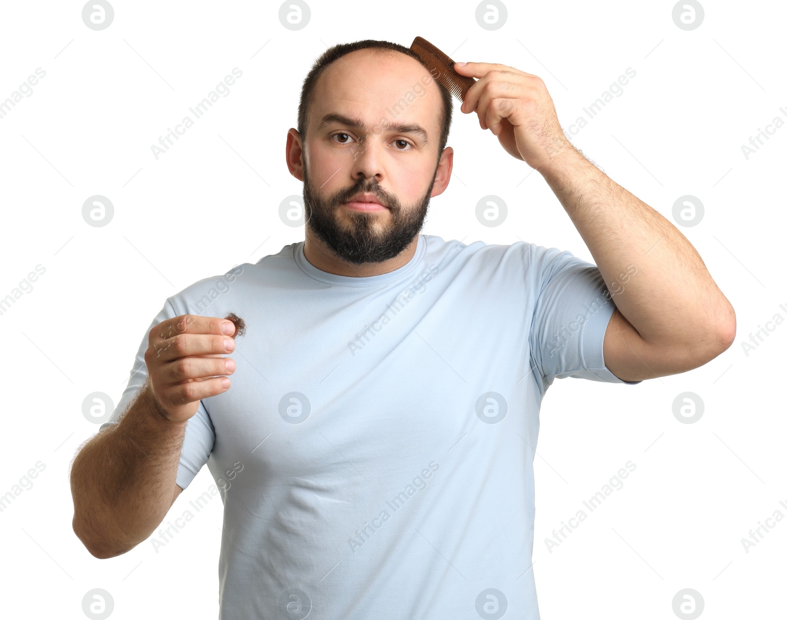 Photo of Baldness problem. Man with comb and clump of lost hair on white background