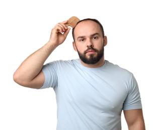 Photo of Baldness problem. Man brushing his hair with comb on white background