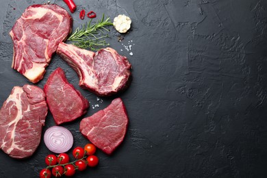Photo of Pieces of raw beef meat, spices and tomatoes on black table, flat lay. Space for text