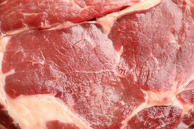 Photo of Piece of raw beef meat as background, closeup
