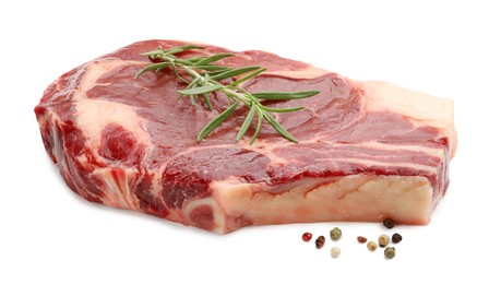 Photo of Piece of raw beef meat and spices isolated on white