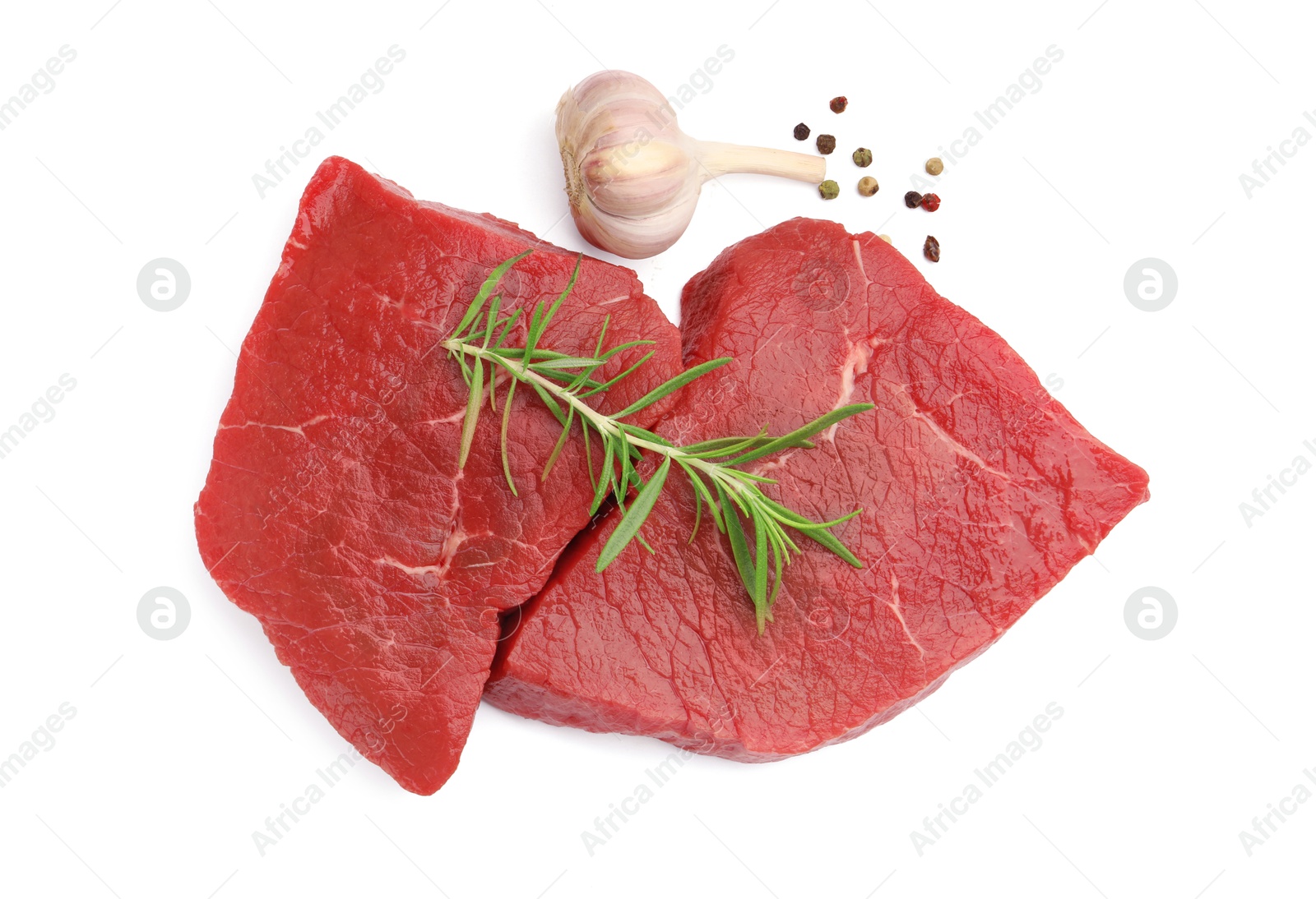 Photo of Pieces of raw beef meat and spices isolated on white, top view