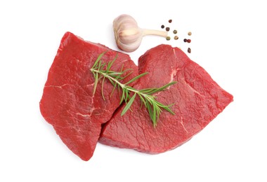Photo of Pieces of raw beef meat and spices isolated on white, top view