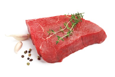 Photo of Piece of raw beef meat and spices isolated on white