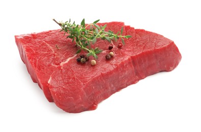 Photo of Piece of raw beef meat and spices isolated on white