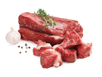 Photo of Pieces of raw beef meat and spices isolated on white