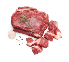 Photo of Pieces of raw beef meat and spices isolated on white, top view