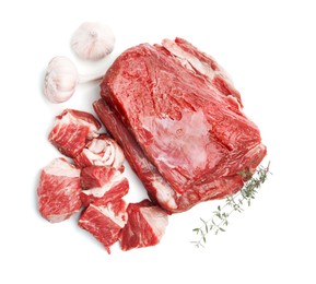 Photo of Pieces of raw beef meat and spices isolated on white, top view
