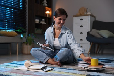 Photo of Happy student preparing for exam on floor at home