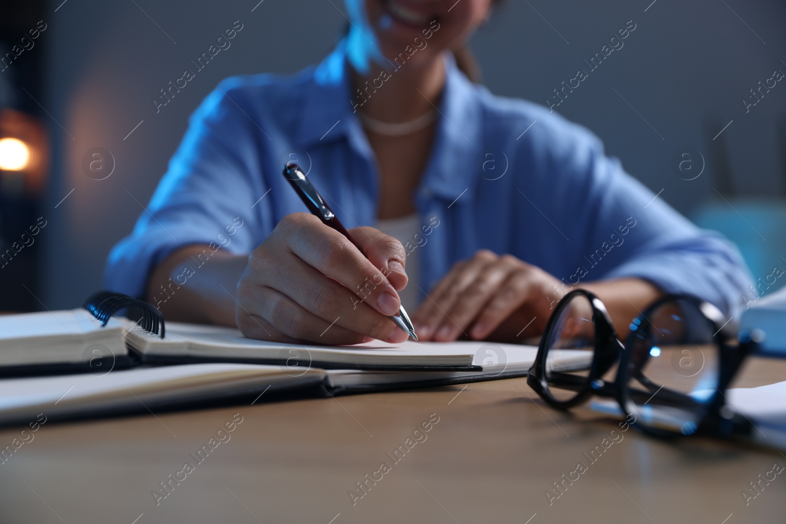 Photo of Student preparing for exam at wooden desk indoors, closeup