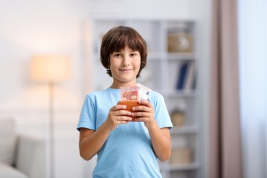 Photo of Boy with his pocket money in wallet at home