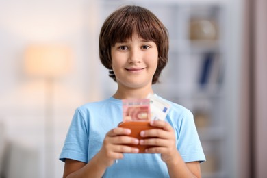 Photo of Boy with his pocket money in wallet at home