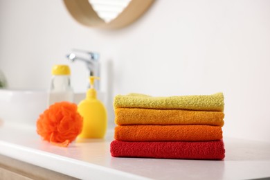 Photo of Stack of fresh terry towels on counter near sink