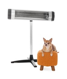 Photo of Cute little dog on pouf near electric heater against white background