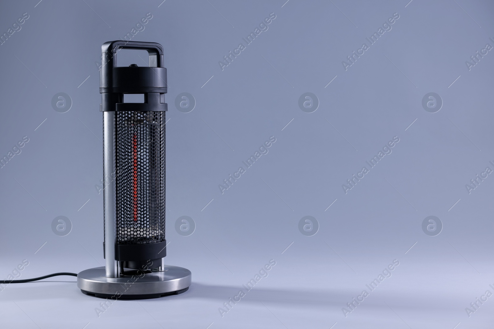 Photo of Modern electric heater on light grey background, space for text